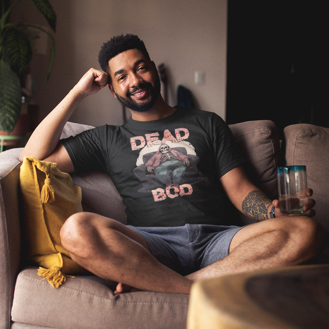 Deadbod_short_sleeve_unisex_t-shirt_mockup_man_on_couch